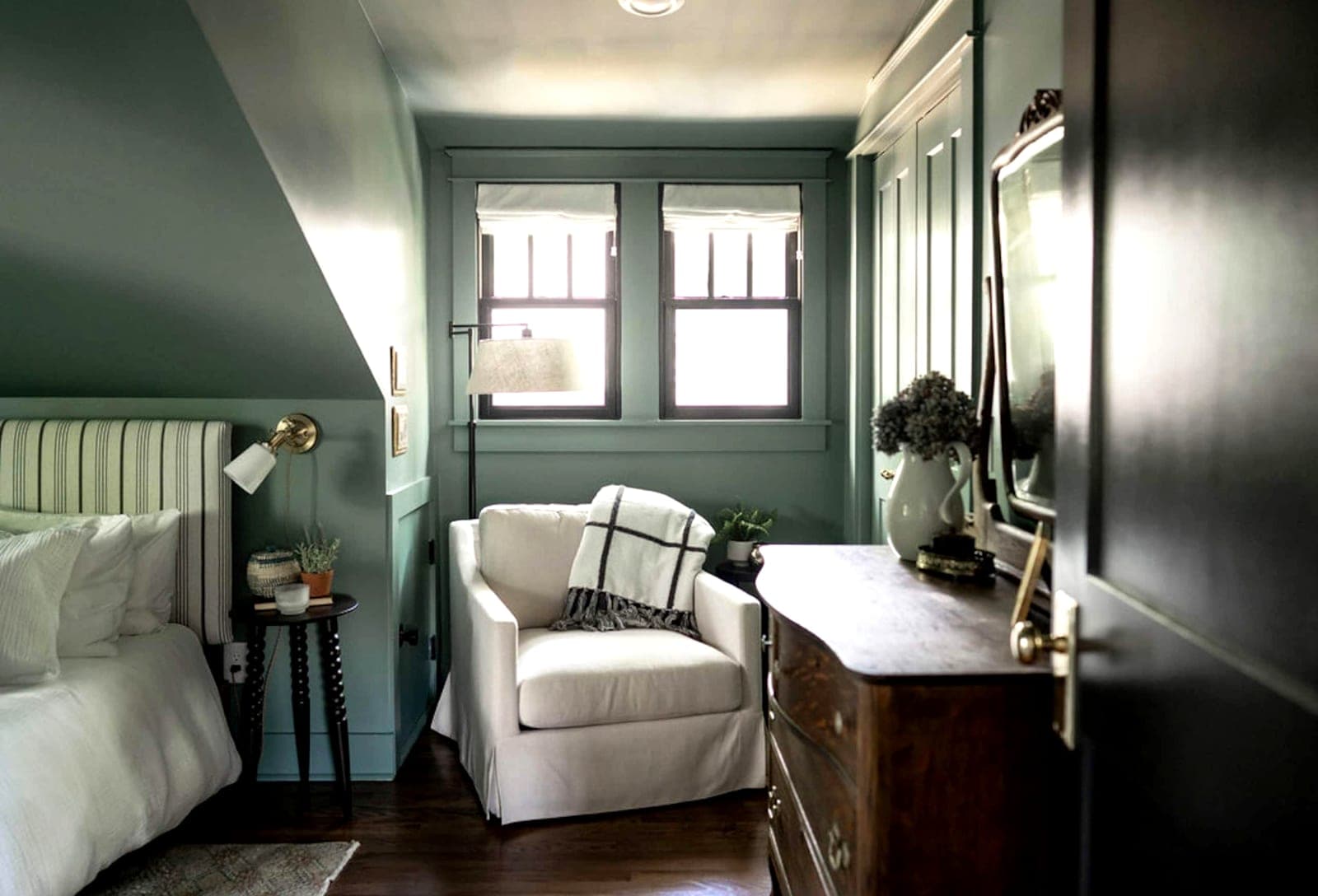 A Boost-managed Nashville sitting room — sage panelling and a slipcovered chair