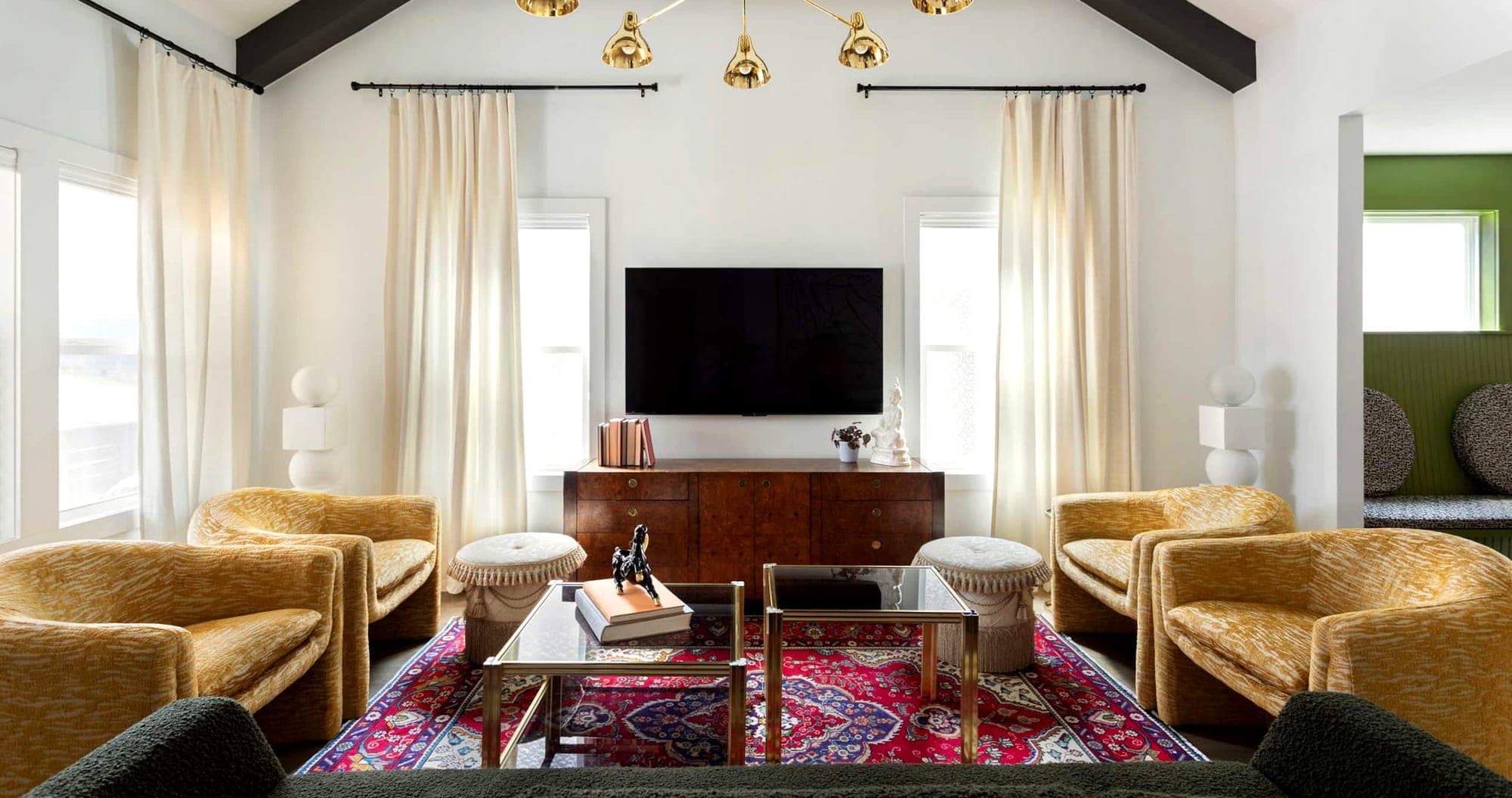A Boost-managed Nashville living room — exposed beams, a brass pendant and layered rugs